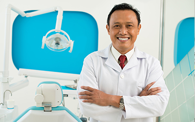 A male dentist smiling