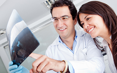 Dentist and patient looking at x-rays