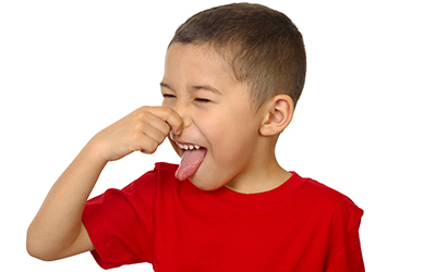A boy plugging his nose