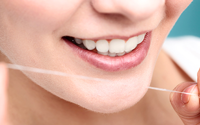 Woman smiling with dental floss