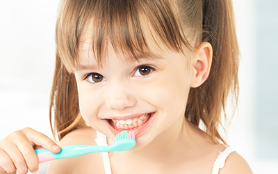 A young girl brushing her teeth